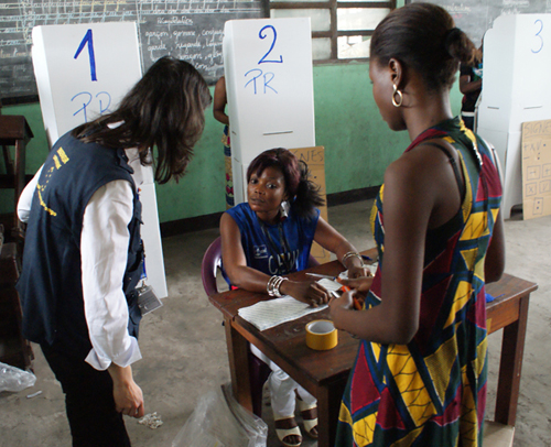 EU election observer talking to women in a polling station