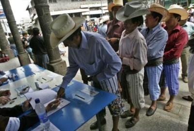 Men queuing to vote