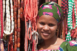 Woman with beaded necklaces in background