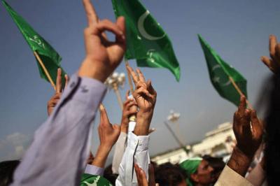 Pakistani flags and hands forming the peace sign