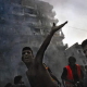 Lebanon, Tyre, 27 july 2006. In the city centre, on the ruins of a building just bombed by the Israeli air force. People are looking for survivors while trying to put out the fire. Liban.