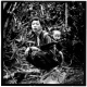 A Hmong freedom fighter with his son at their hidden camp.