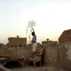 In the city of the dead, the huge cemetery of Cairo, people live in mausoleums or tumbledown houses built between the graves and on the roofs, where children play with kites.