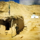 Day Kundi Province, at a general store near the cemetery. Background: a mausoleum built around the grave of a saint.