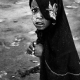 A girl running away from the genocide in Darfur. She survived a storm in the middle of the desert.