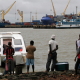 People gather around a speedboat of the type believed to be used by drug traffickers. Guinea Bissau, with its many water ways, is fast becoming a major route for drugs smuggling.