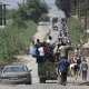 Nahr el Bared, 23 May 2007. Palestinian refugees are crossing to safety from the southern entrance of their besieged camp. The refugees fled the camp by foot, in cars or pickup trucks when the guns fell silent after three days of ferocious fighting.