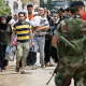 Nahr el Bared, 26 May 2007. Palestinian refugees fleeing the besieged camp. The Lebanese government offered the civilians trapped inside a chance to leave the camp. Sniper fire had stopped all but a few dozens from fleeing.