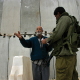 A Palestinian bound for Jerusalem crosses the Kalandia checkpoint near Ramallah in the West Bank, April 20, 2002. The checkpoint, one of the largest Israeli military checkpoints in the West Bank.