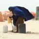 A young Somali woman draws water in the village of Haafun. The aftermath of the tsunami on this part of the coast left the wells polluted by the sea water.