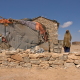 A young Somali woman standing in front of her house in the city of Garowe.