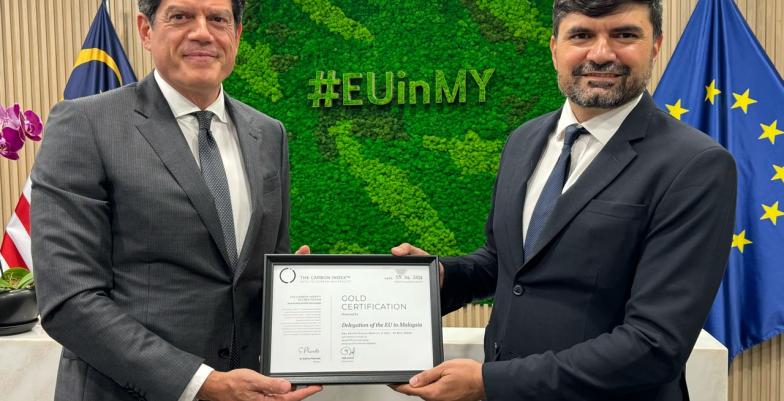 EU Ambassador Rokas displaying latest suistainability certificate