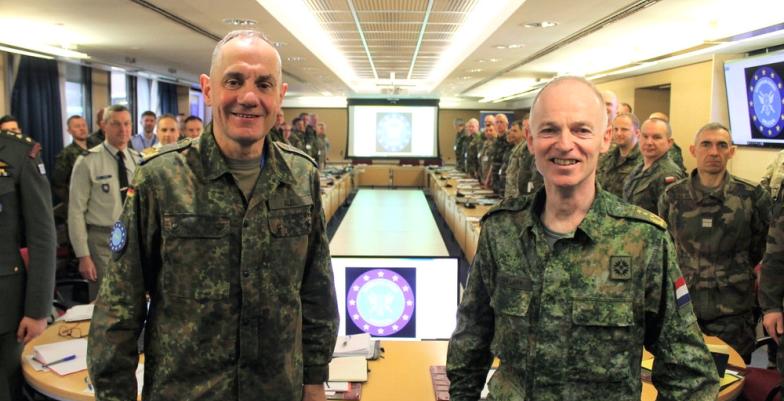 EU military commanders and staff in operations HQ, smiling for camera.