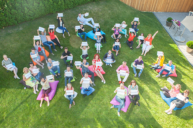 Workers from the MANEZH company, in Cherkassy, Ukraine, celebrate the one year anniversary of signat