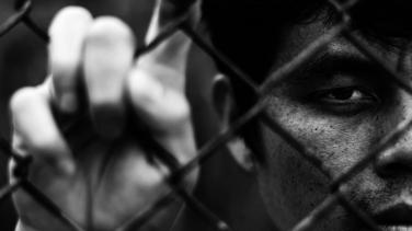 Man behind bars - victims of trafficking