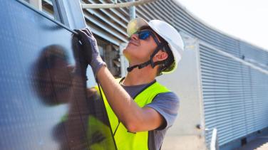 Construction worker mounting a solar panel