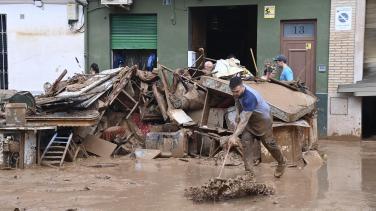 A man cleaning the mud during the flood