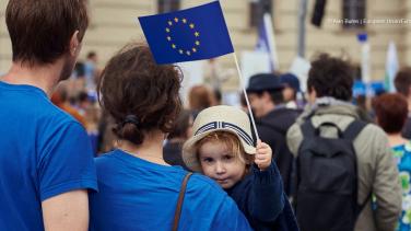 Mum with kid waving a EU flag