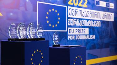 Awards in front of EU emblem