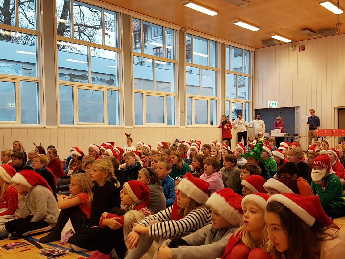 Group of children with Santa Claus hats during an event