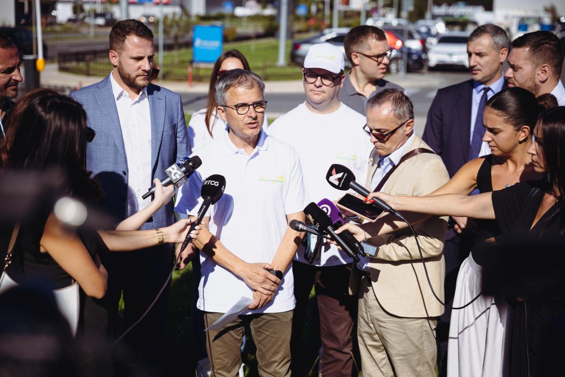 Bernard Brunet standing and giving statement to the media