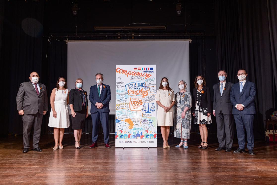 Group of people posing on stage with an equality mockup