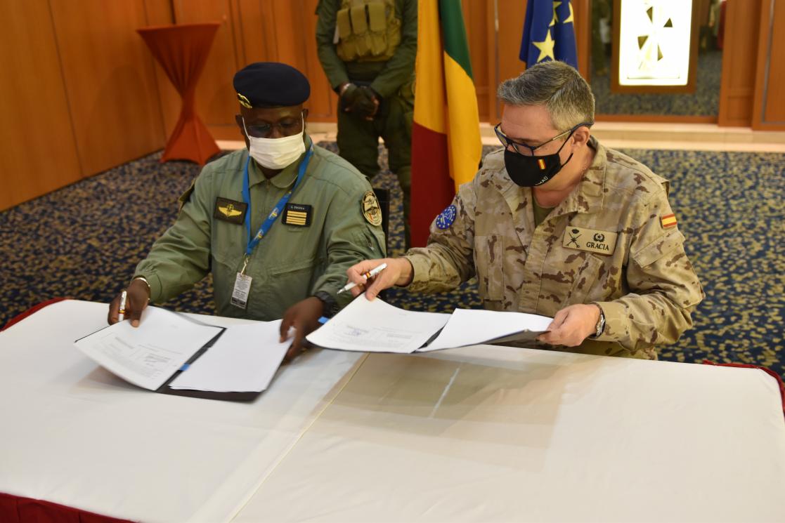 Two people signing documents