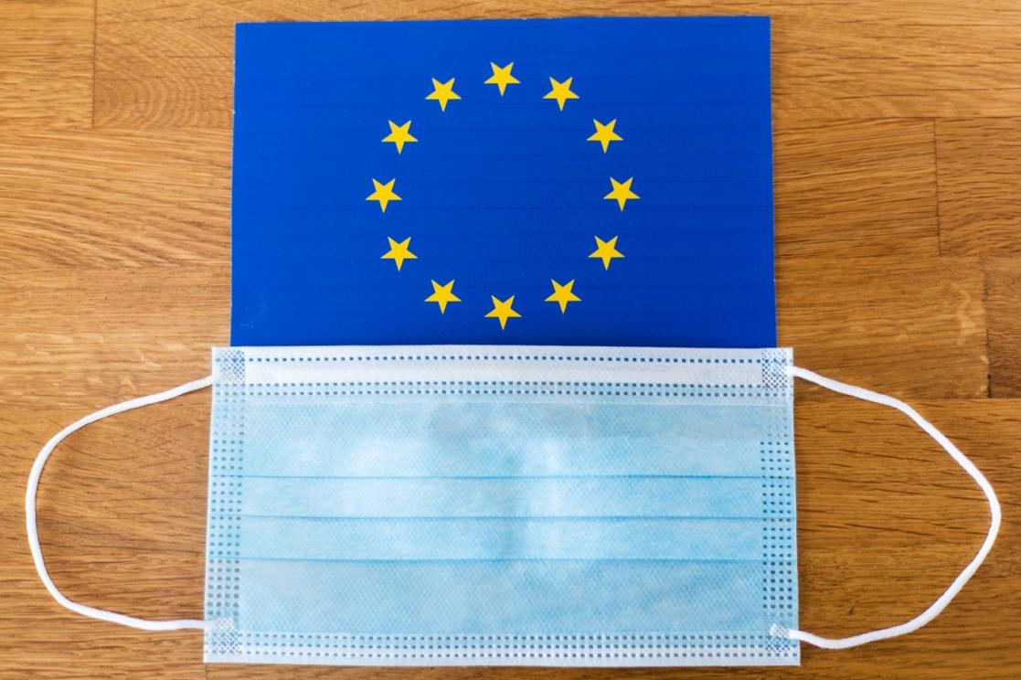 A mask and an EU flag