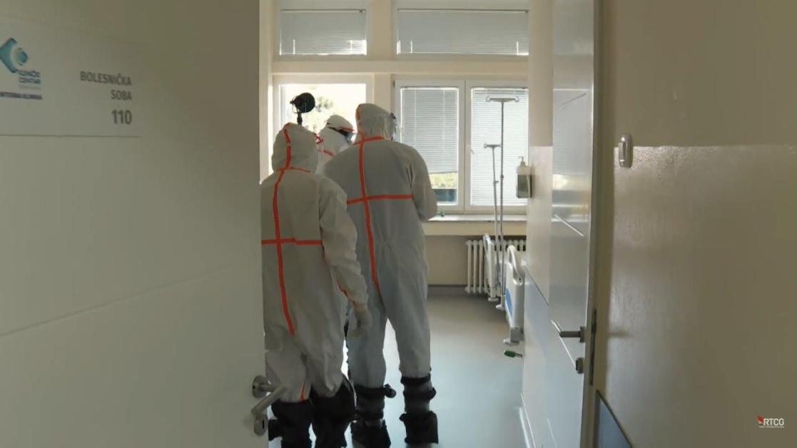 Medical personnel wearing safety overalls