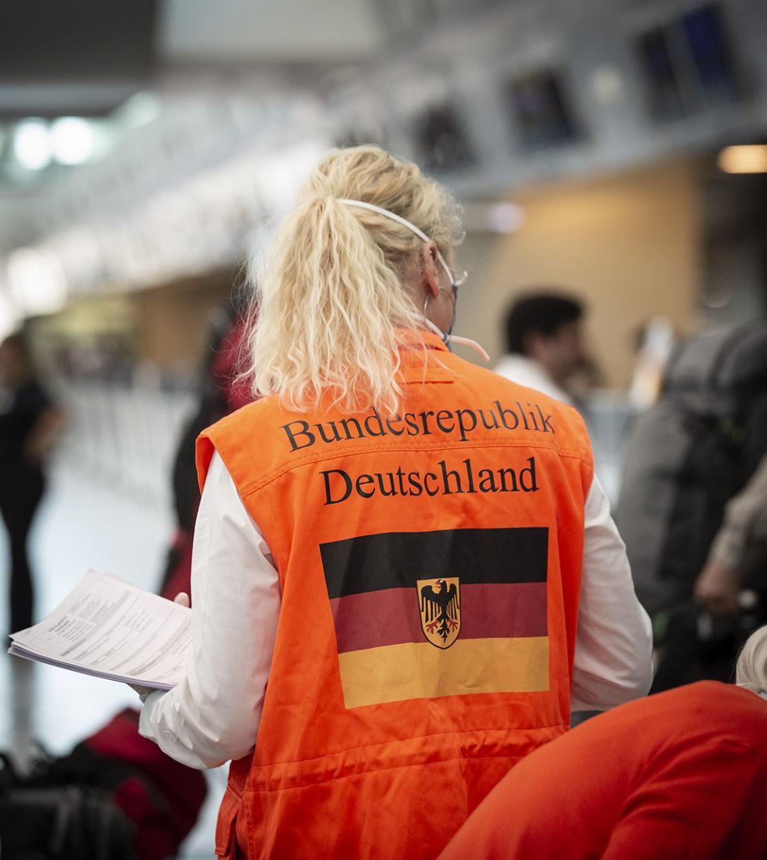 Woman wearing an orange waistcoat with the German flag