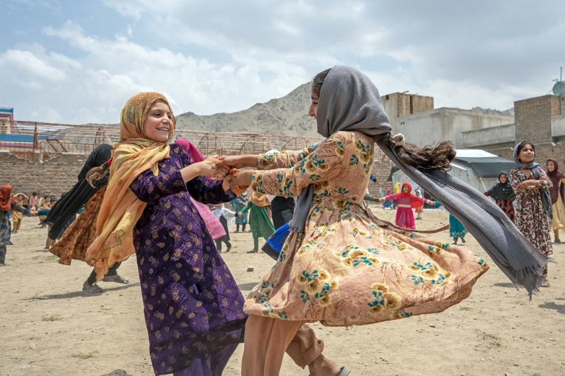 Two girls in veils dancing happily