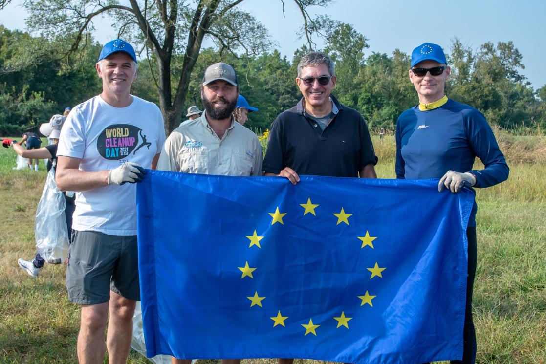 Four individuals hold up an EU flag at Kenilworth Park in D.C.