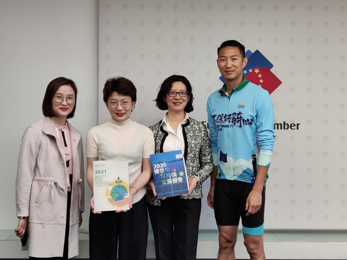 Man dressed as a cyclist posing with three women