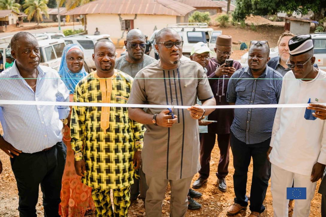 Programme Manager, Julius I.K Foday cutting the tape to inaugurate the newly built guesthouse