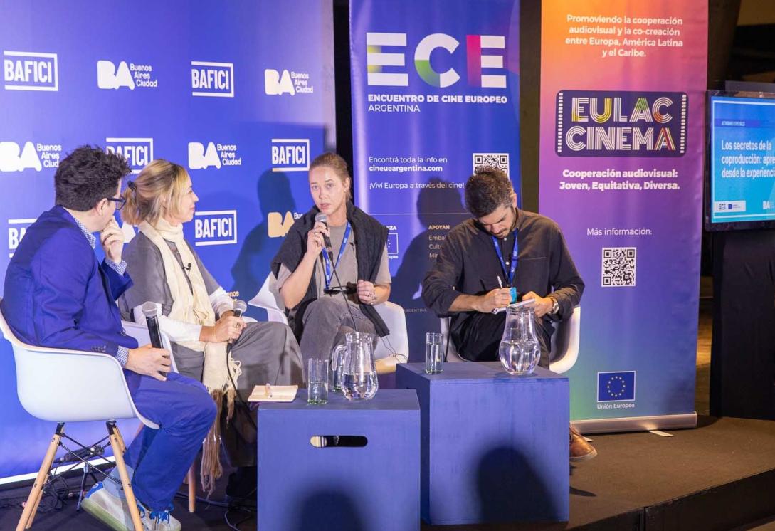 Filmmakers discuss their craft on a stage at a festival.