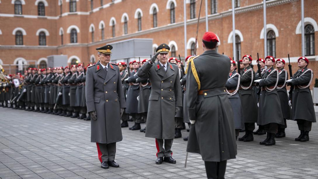 Senior military officer takes salute from honour guard in Austria.