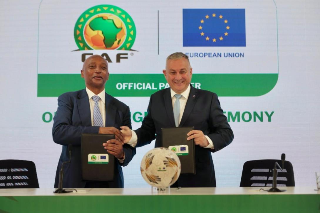 Two men dressed in formal shaking hands