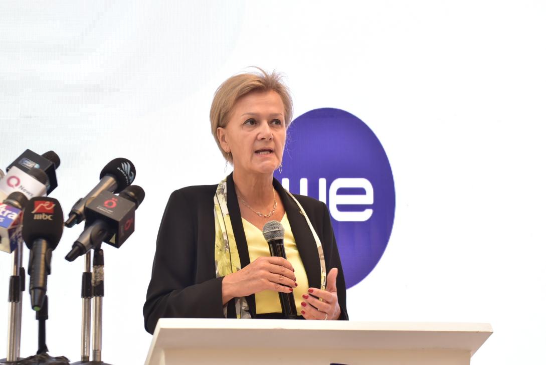 Lady standing and holding a microphone