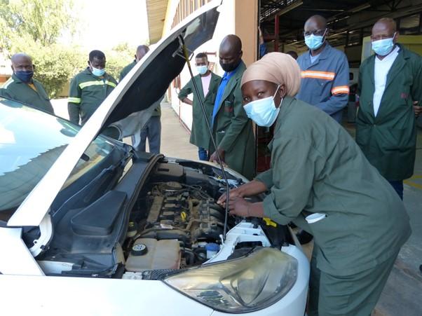 Woman checking the engine of a car