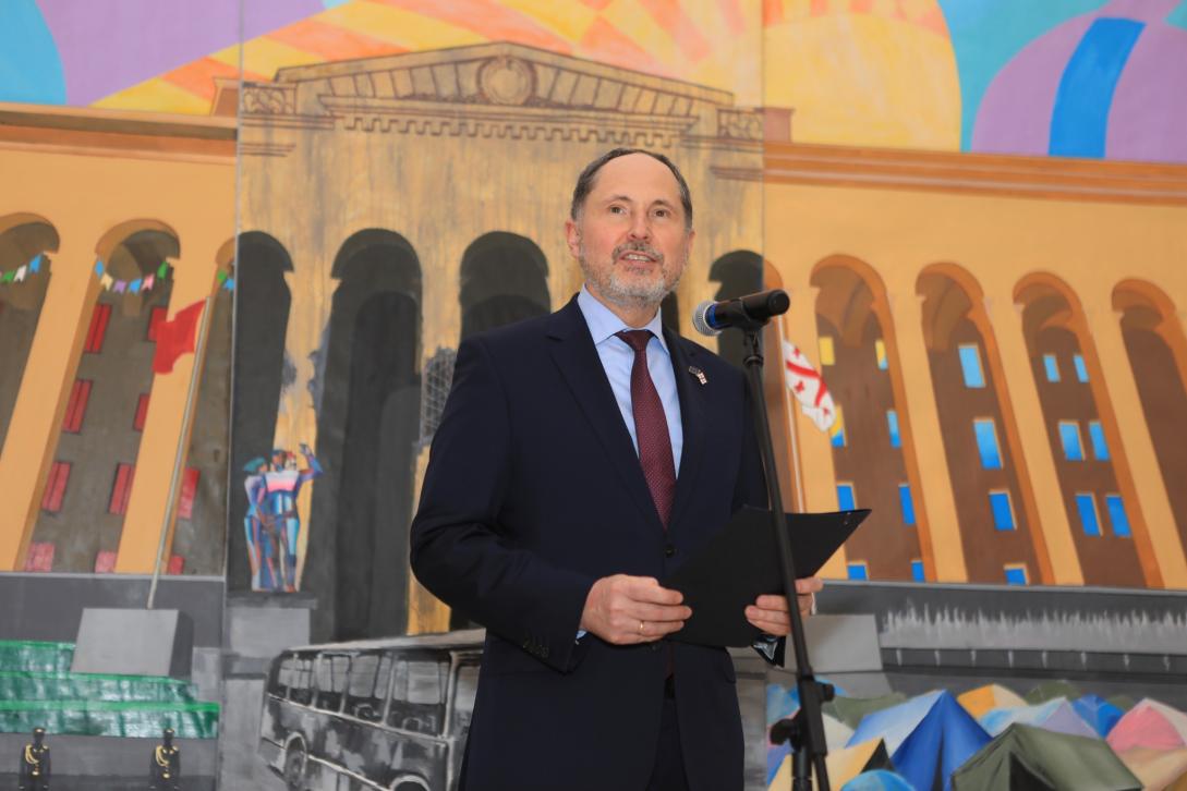 Ambassador Herczynski in front of painting