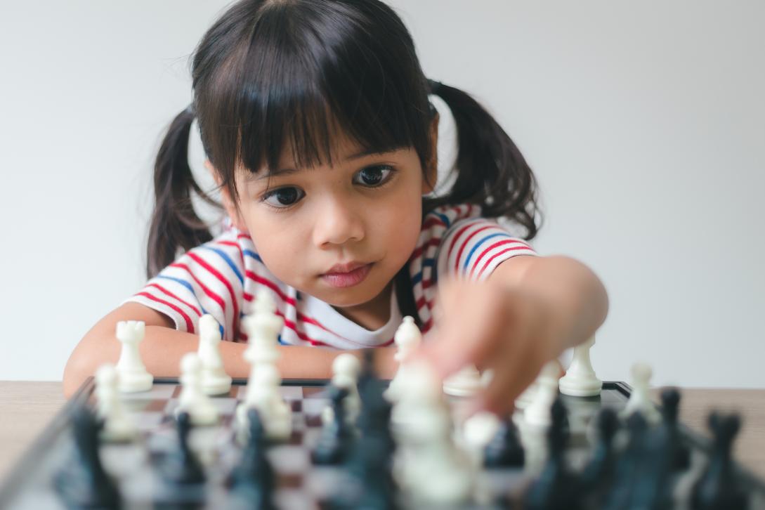 International Day of the Girl Child - Asian girl playing chess
