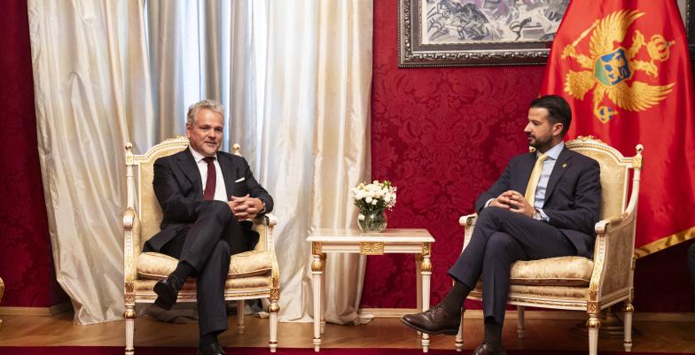 Ambassador Johann Sattler and President Jakov Milatovic sitting in white chairs. 