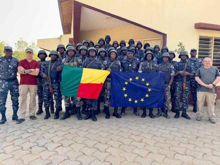 Family photo with Benin and EU flags. 