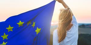 Woman holding the EU flag - Shutterstock