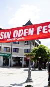 A large red banner strung across the open space between buildings that reads "KOLASIN OPEN FEST" 