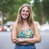 Young woman with long blond hair posing in front of the camera