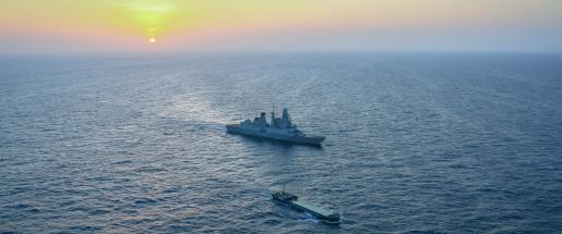 two military vessels in sunset