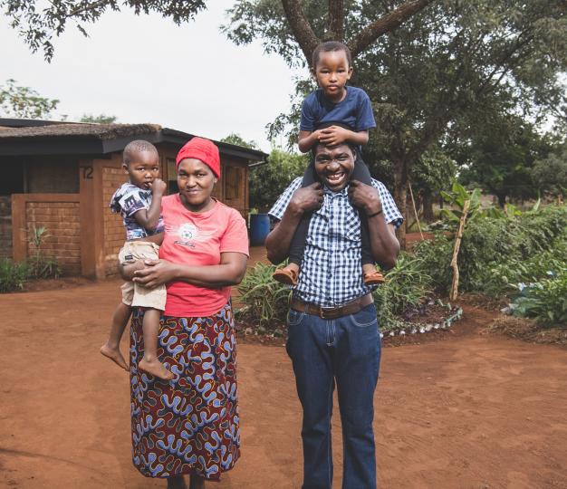 Emaswati family standing in front of their home