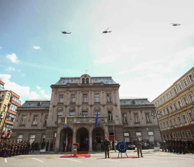 Members of the BiH Armed Forces and EUFOR watch helicopter flypast in front of Army Hall in Sarajevo.